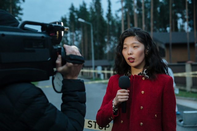 A reporter speaks into the camera