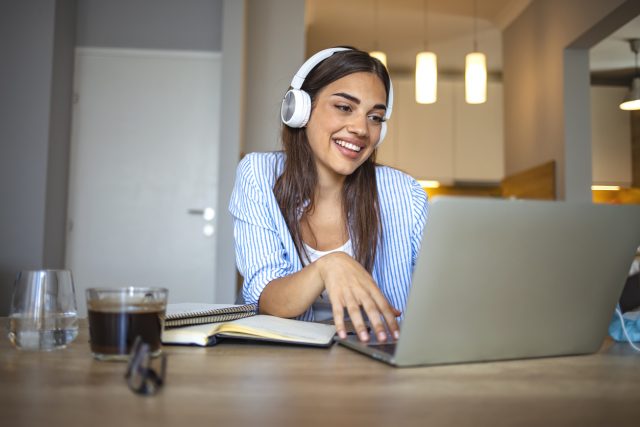 A young woman enjoys her online classes.