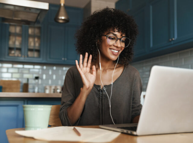 A young woman greets her online accent coach.