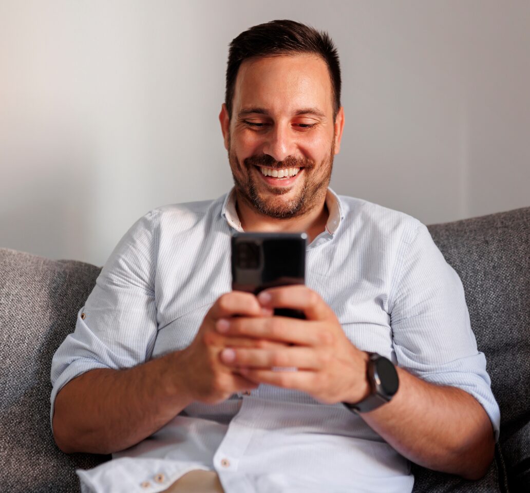 A man enjoys practicing his accent using his phone voice recorder.