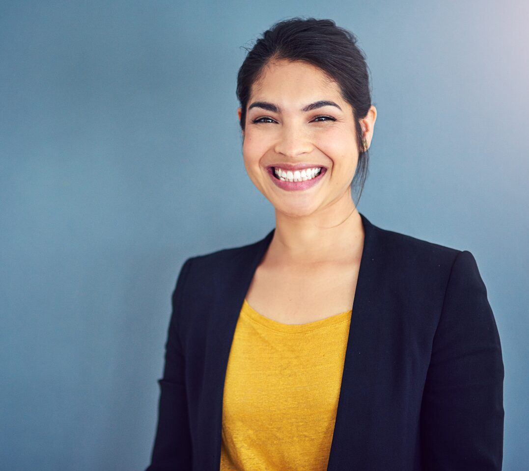 A woman smiles with confidence