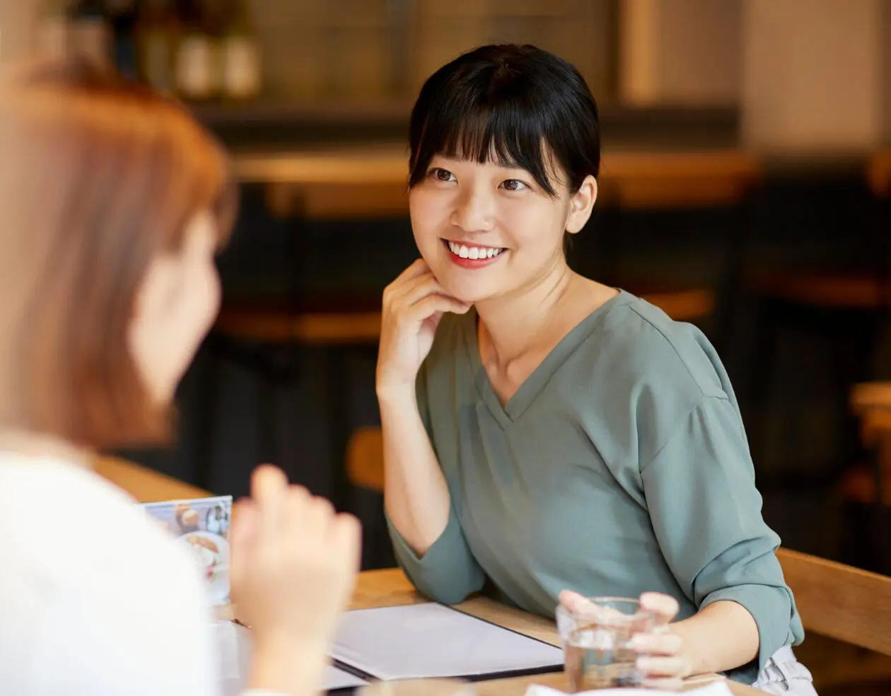A language learner listens to a native speaker in casual conversation