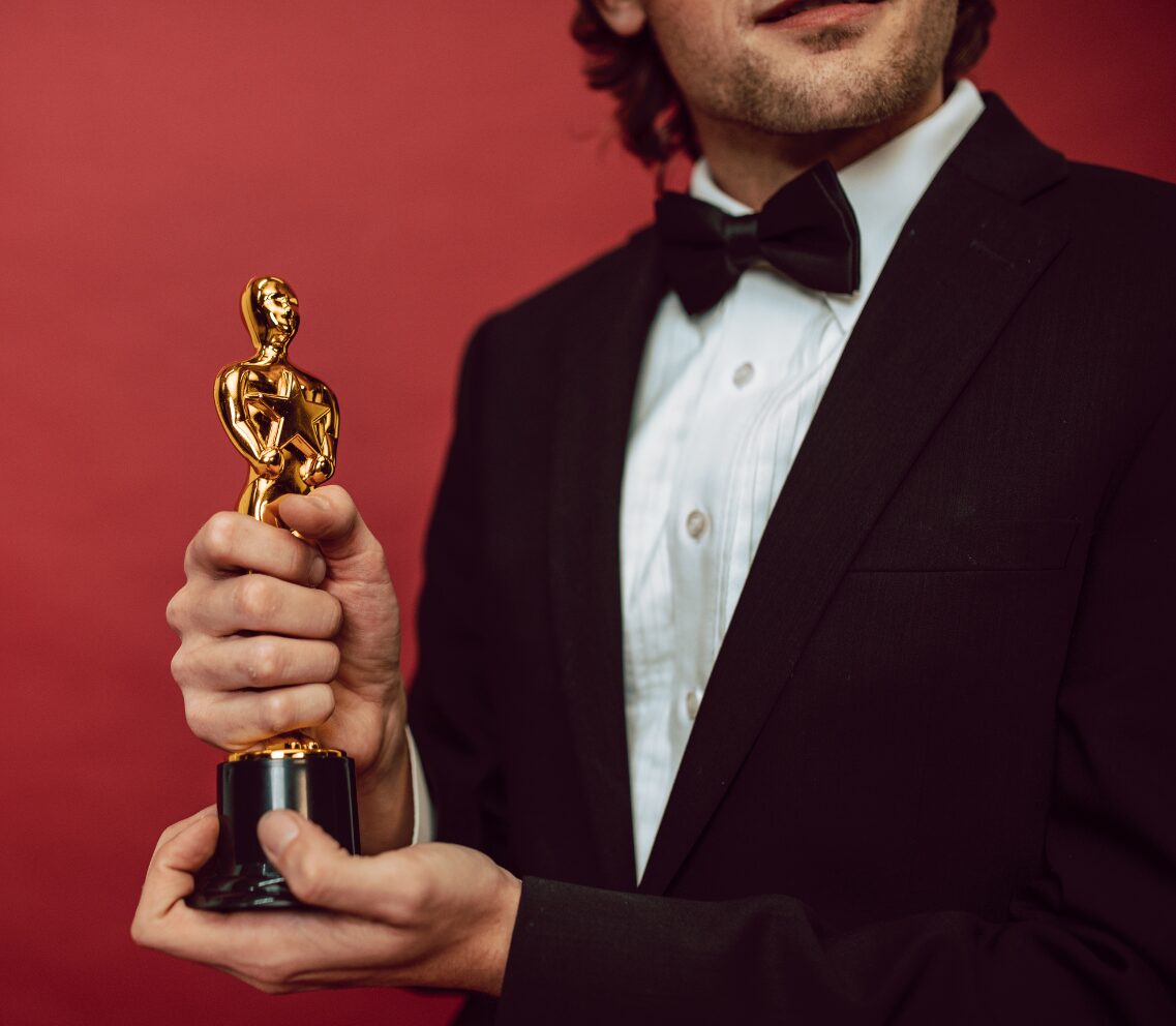 An actor holds a Grammy award