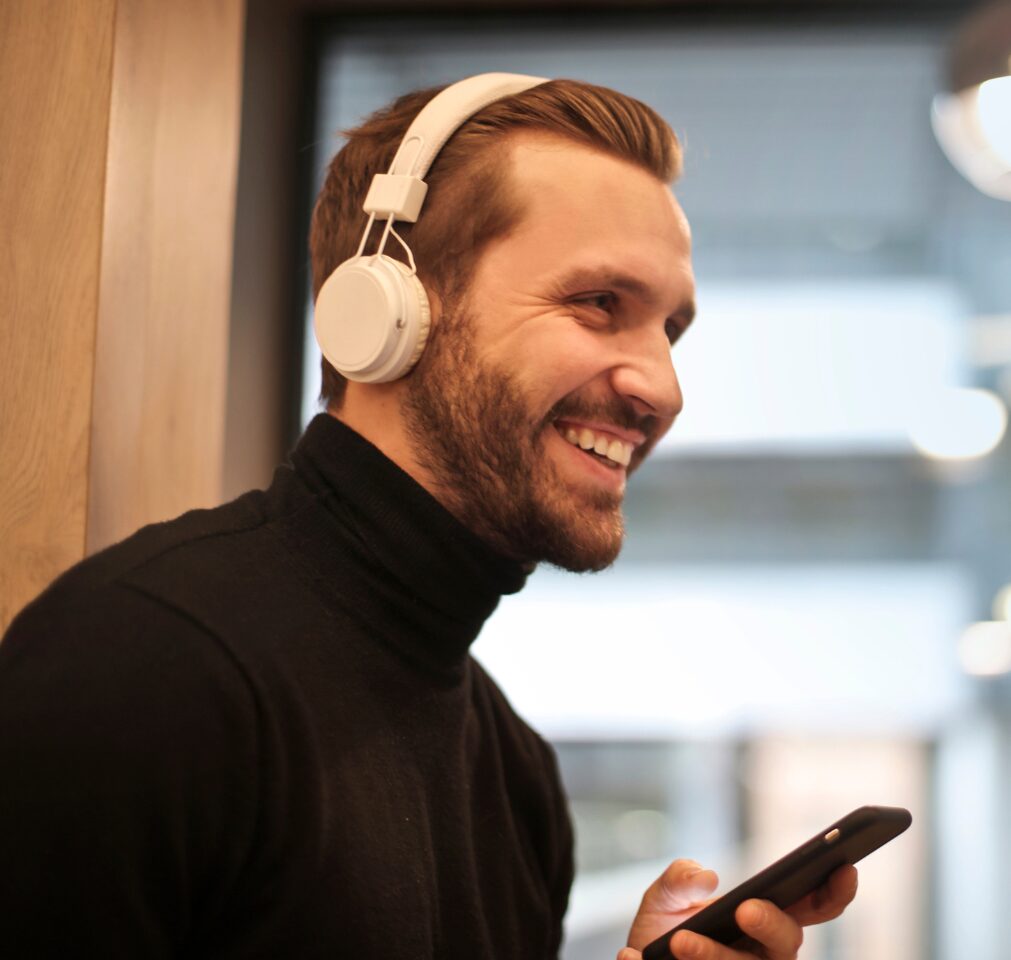 A man listens to a podcast on his phone