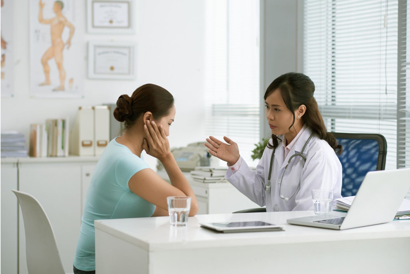 A physician explains their diagnosis to a patient.