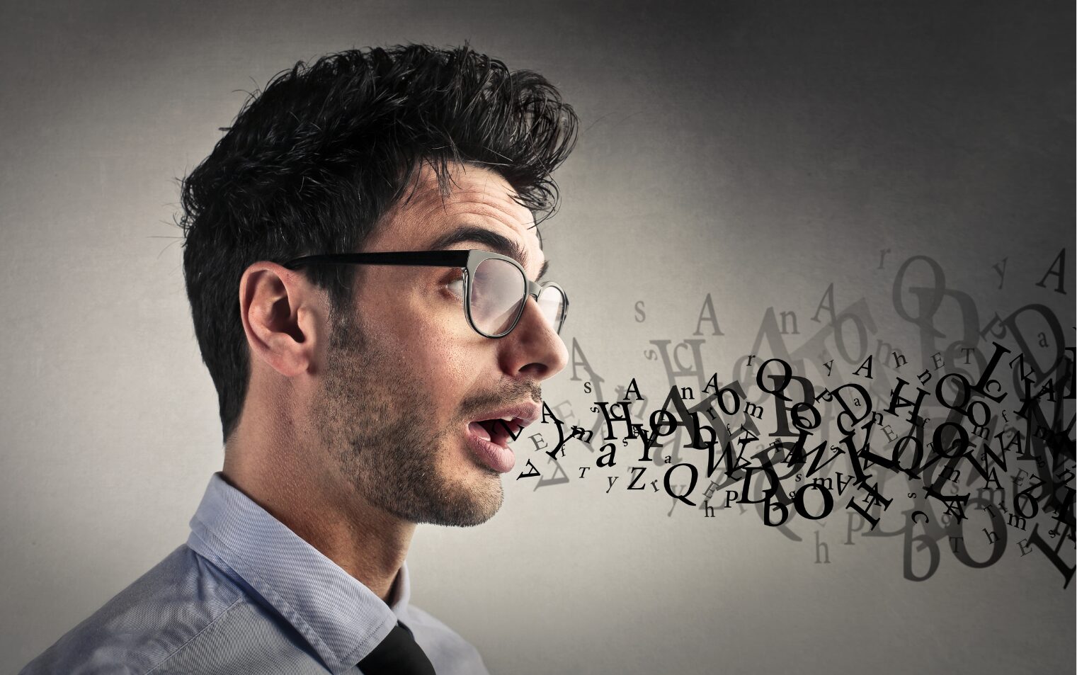 Unrecognizable letters come out as a man speaks.